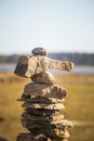 Sunny riverside landscape of a dried river bed and rocks. Stone balancing constructions near the river. Royalty Free Stock Photo