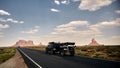 Sunny scenery of a car on the road located in Monument Valley, Arizona - USA Royalty Free Stock Photo