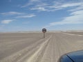 Sunny scenery of a desert road with a speed limit signpost in Skeleton Coast, Namibia, Africa Royalty Free Stock Photo