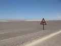 Sunny scenery of a desert road with a traffic signpost in Skeleton Coast, Namibia, Africa Royalty Free Stock Photo