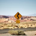 Sunny scenery of a yellow traffic signpost in the Valley of Fire State Park in Nevada, USA Royalty Free Stock Photo