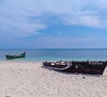 A sunny seascape adorned by a small sailboat, its white sails catching the breeze as it peacefully navigates the azure waters.