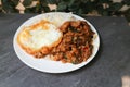 Sunny side up egg and stir fried park with chilli paste Royalty Free Stock Photo