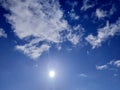 Sunny sky background. Blue sky with clouds, sun shining and moon. Royalty Free Stock Photo