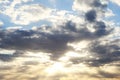 Sunny sky with sun rays shining from behind clouds in blue and yellow colors Royalty Free Stock Photo