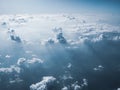 Sunny sky with white clouds on plane. Cloudscape as seen on aircraft.