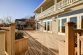 Sunny spacious walkout deck of luxurious waterfront home Royalty Free Stock Photo