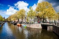 Sunny spring day in Amsterdam. Canal view with boats and bicycles, Netherlands Royalty Free Stock Photo