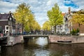 Sunny spring day in Amsterdam. Canal view with boats and bicycles, Netherlands Royalty Free Stock Photo