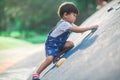 A lively little boy is playing a climbing game