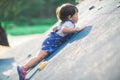 A lively little boy is playing a climbing game