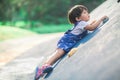 A lively little boy is playing a climbing game