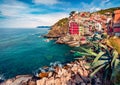 Sunny summer cityscape of Riomaggiore, first city of Cique Terre sequence of hill cities. Bright morning view of Liguria, Italy, E