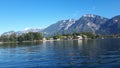 Sunny, summer day at the calming lake. Clear sky, mountains in the back and clear water. Royalty Free Stock Photo