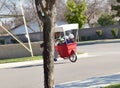 A father giving his children a ride in a cart from his bicycle