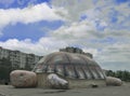 a huge inflatable turtle is depicted against a blue sky.