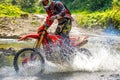 Motorcycle Enduro and Athlete in Water Spray