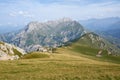 WALLPAPER sunny summer day in the mointains Green fields in front of a great mountain peak Massive rocks with blue sky and clouds