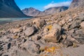 Sunny summer day in a remote arctic valley of Akshayuk Pass, Baffin Island, Canada. Steep cliffs and autumn colors. Schwarzenbach