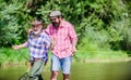 Sunny summer day at river. Fisherman family. Hobby sport. Fishing peaceful activity. Father and son fishing. Rod tackle Royalty Free Stock Photo