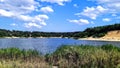 Sunny summer day on the shore of a blue lake quarry