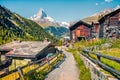 Sunny summer morning in Zermatt village with Matterhorn Monte Cervino, Mont Cervin peak on backgroud. Beautiful outdoor scene in Royalty Free Stock Photo