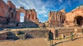 Sunny summer view of ruine of Greco-Roman theater, Sicily, Itale, Europe. Bright morning cityscape of Taormina town and Etna volca