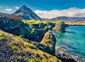 Sunny summer view of small fishing village at the foot of Mt. Stapafell - Arnarstapi or Stapi. Attractive morning scene of Iceland