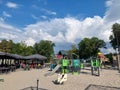 Sunny terras with playground and various playing equipment like a slide for kids