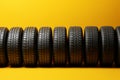 Sunny tire display Yellow backdrop with an orderly arrangement of tires