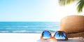 Sunny tropical beach vacation background; glasses and palm tree reflex Royalty Free Stock Photo
