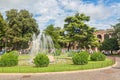 Sunny view of fountain in the park near famous landmark of Verona Arena or Amphitheater. Verona City in Italy. Royalty Free Stock Photo