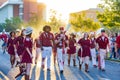 Sunny view of the student Marching Band walking in Homecoming parade Royalty Free Stock Photo
