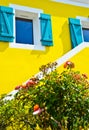 Sunny view of yellow facade with blue window frames Royalty Free Stock Photo