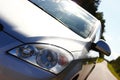 Sunny weather, grey car on the road background. Village style, summer. Mirroring sky on the car. reflection Royalty Free Stock Photo