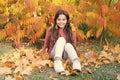 Sunny weekend. Autumn warm. Stylish smiling girl in a autumn park. Fallen leaves. Autumn nature. Happy small kid