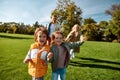 Sunny weekend. Excited family running outdoors on a sunny day Royalty Free Stock Photo
