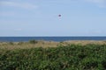 A kite is in the air on the beach of the village Am Schwarzen Busch on Poel island.