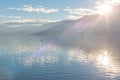 Sunlight shining over mountains and Skaha Lake just before sunset in winter Royalty Free Stock Photo
