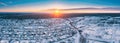 Sunny Winter Day. Aerial Panoramic View Of Small Town Village Cityscape Skyline Traffic In Snowy Landscape