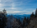 Lengries, Germany - December 28th 2023: Panoramic view over a forest towards alpine valleys and mountains