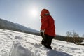 A boy walks through deep friable snow in the winter