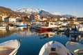 Sunny winter day. Fishing boats in harbor in Mediterranean town at foot of snowy mountains. Montenegro, Tivat city Royalty Free Stock Photo