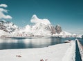 Sunny winter day in Reine, fishing village in Norway, drone shot on amazing landscape in Lofoten. Lovely clouds and blue sky Royalty Free Stock Photo