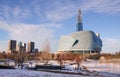 Sunny winter day sunset in Winnipeg downtown. Winter view on Canadian Museum for Human Rights in foreground and high Royalty Free Stock Photo