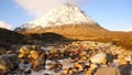 Sunny winter morning at frozen river Coupall at delta to river Etive. Snowy cone of mountain Stob Dearg 1021 metres high. Higland