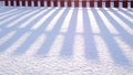 Sunny winter, the shadow of the fence on the snow, nature landscape, cold season Royalty Free Stock Photo