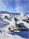 Sunny winter sky resort airial view. Snowy beautiful landscape, skiing and snowboarding