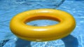 Sunny yellow pool float drifting in refreshing blue water of a serene swimming pool Royalty Free Stock Photo