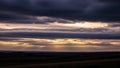 Sunrays break through the cloud layers, casting a golden glow across the horizon Royalty Free Stock Photo